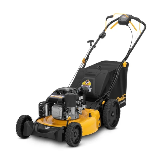 Cub Cadet SC500K walk-behind lawn mower with grass bag and folding handle on a mowed lawn.